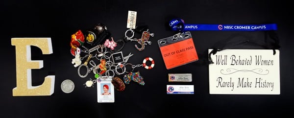 A collection of teachers keyrings, bits and bobs, name tags and lanyards framed for a client