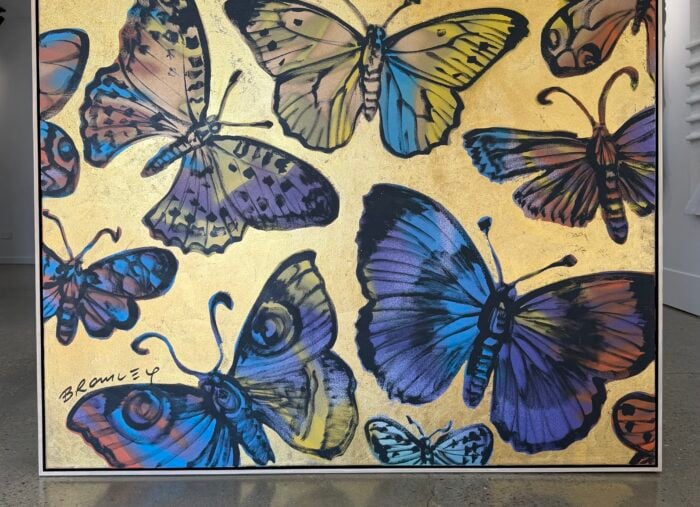 a metallic gold artwork with butterflies by Australian contemporary artist David Bromley, framed in an oak float frame with black inner edge custom made by Dawsons framing gold coast