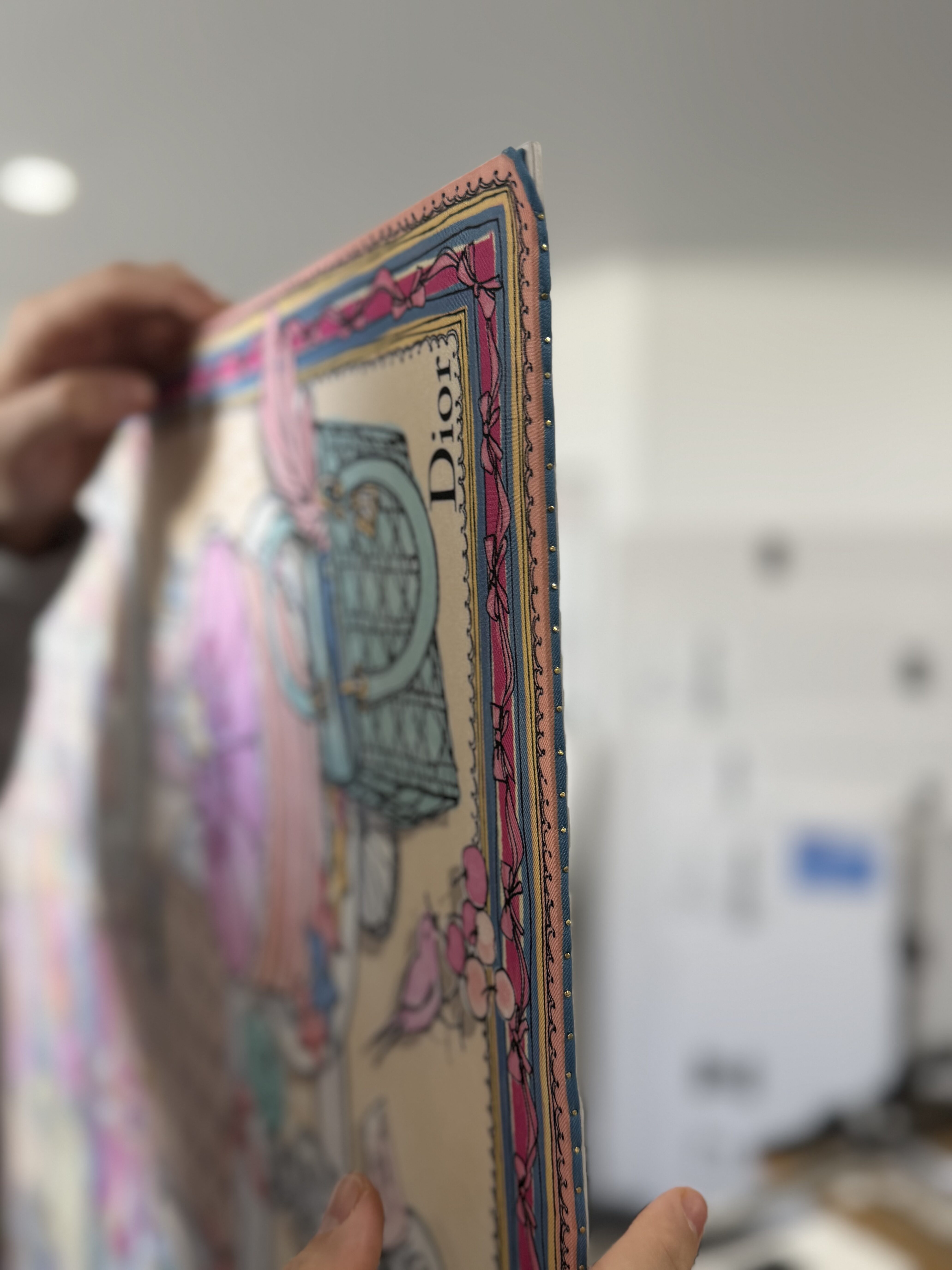 Close up detail of the brass pins used to mount the Dior silk scarf at Dawsons Framing Gold Coast